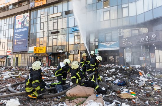 KYIV, UKRAINE - Feb. 25, 2022: War of Russia against Ukraine. Rescue service works near a house destroyed by russian rocket in Kyiv